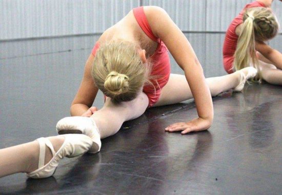 Dancer stretching on the floor.