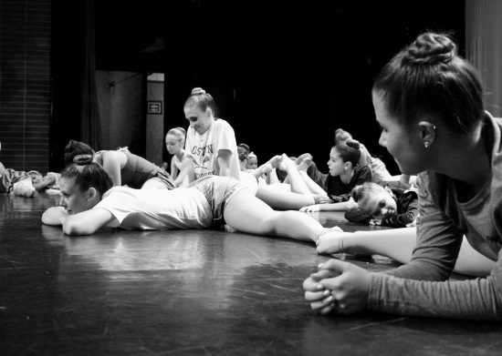 Black and White Photo of Dancers Laying Down